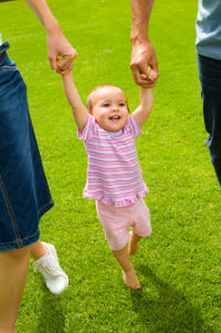 child holding parents' hands